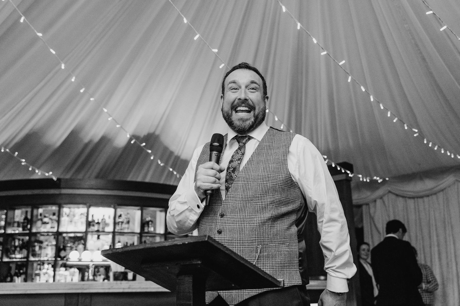 Wedding reception under a white tent with string lights creating a romantic atmosphere.  Virginia Park Lodge Wedding Photographer Cavan Dubl