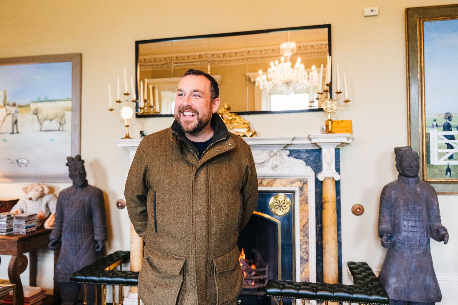 A person in a brown jacket stands smiling in a room. Virginia Park Lodge Wedding Photographer Dublin Meath Ireland
