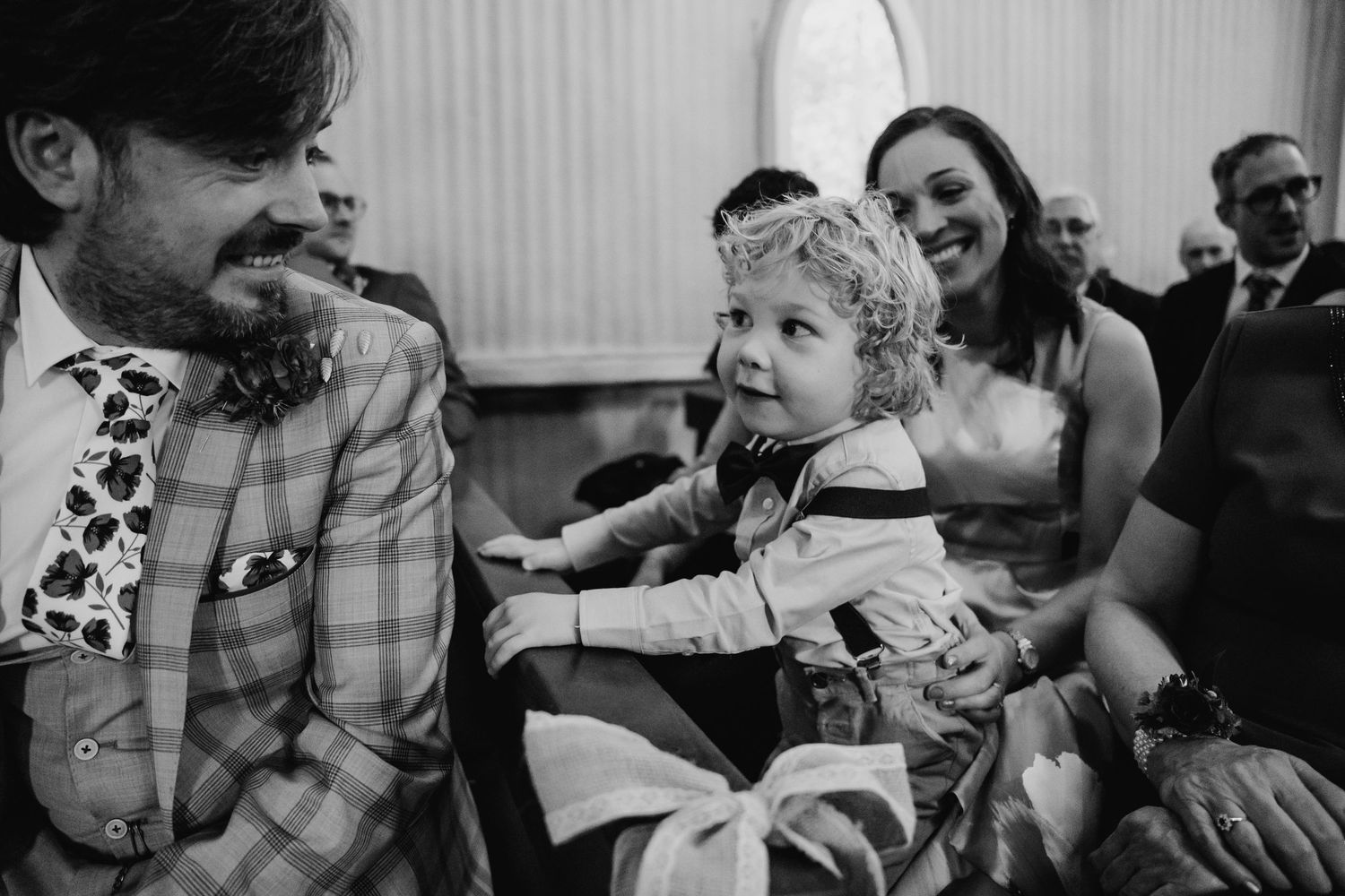 Black and white candid moments of wedding guests laughing and enjoying themselves during a celebration. Wedding photographer Dublin