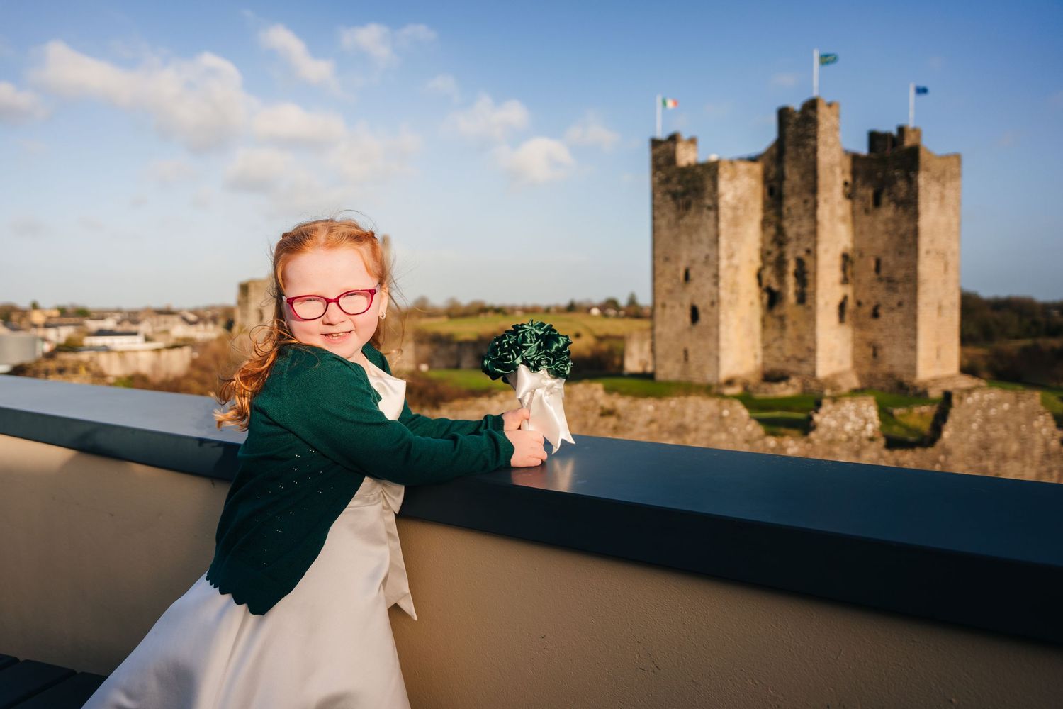 A historic castle provides a stunning backdrop for outdoor wedding photography against a blue sky.  Wedding PHOTOGRAPHER Trim Castle