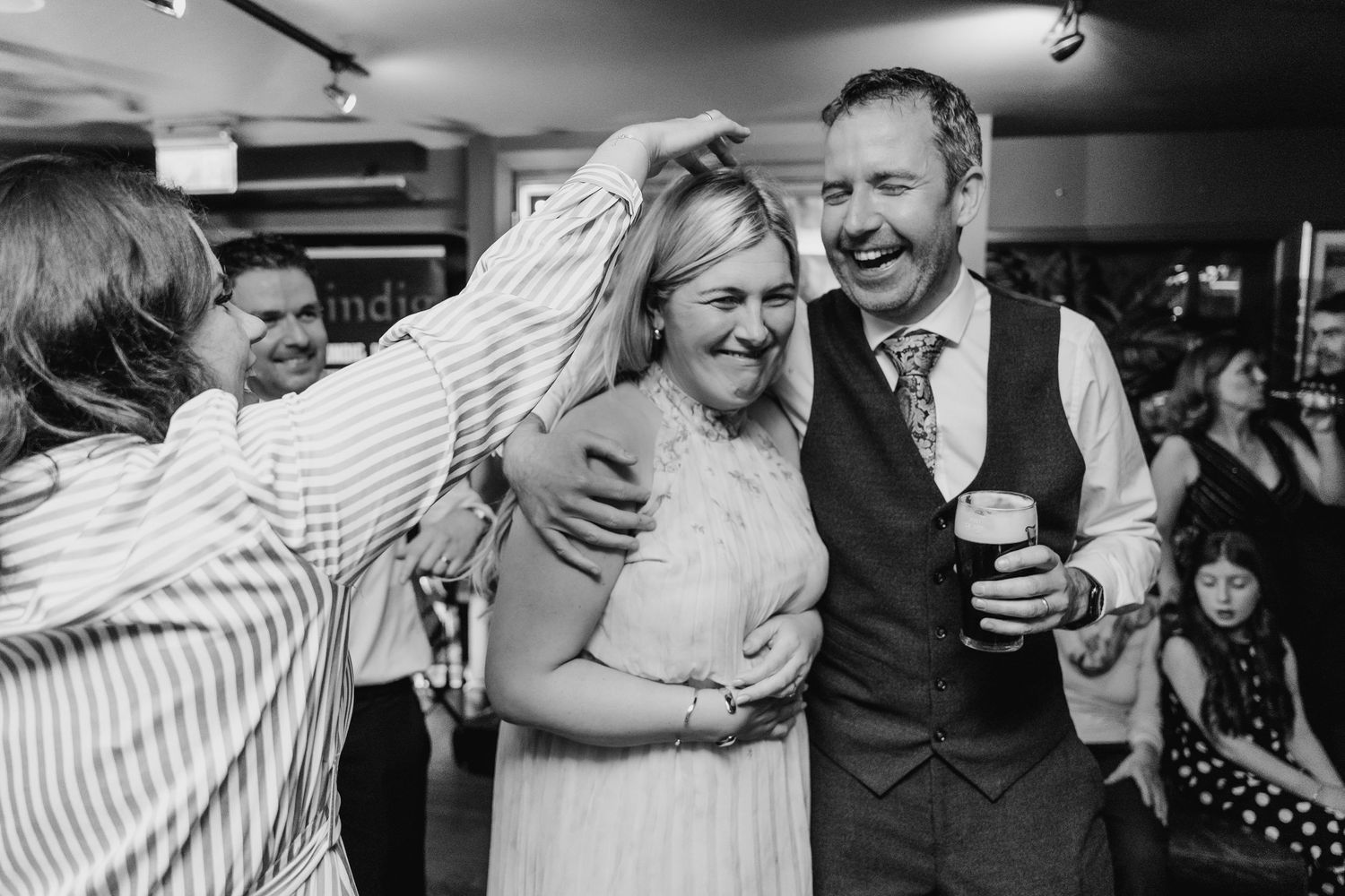 Black and white photographs capturing joyful moments of dancing and celebration at an event. Marco Pierre Dublin Wedding Photographer