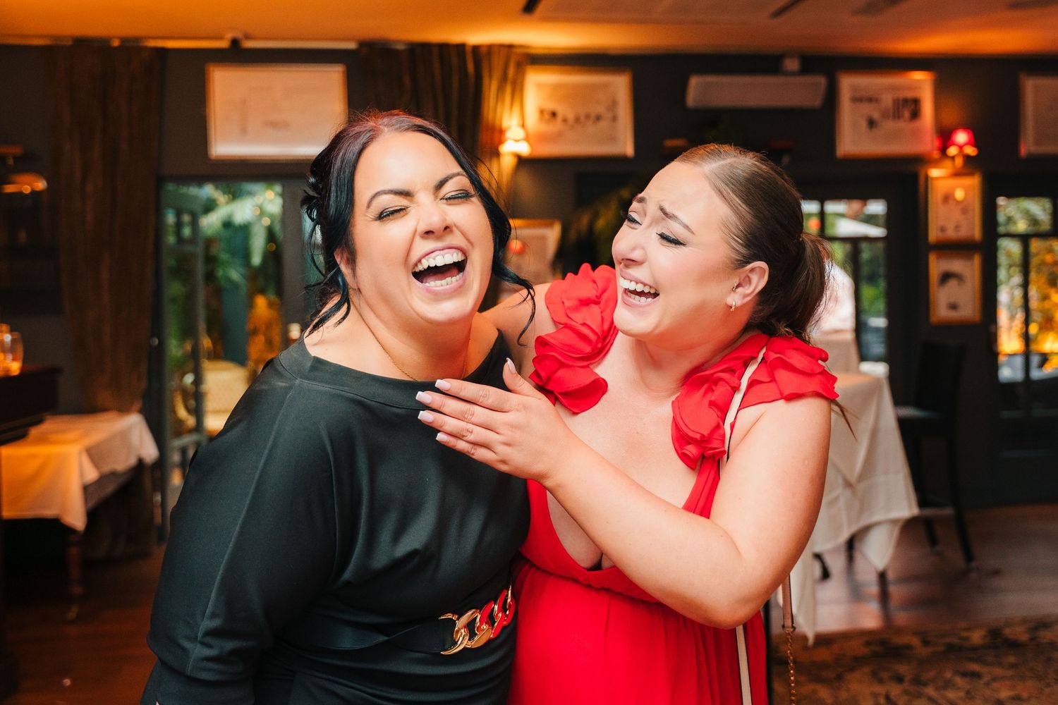 Wedding guests in formal attire enjoying a lively moment at the reception. Marco Pierre Dublin Wedding Photographer