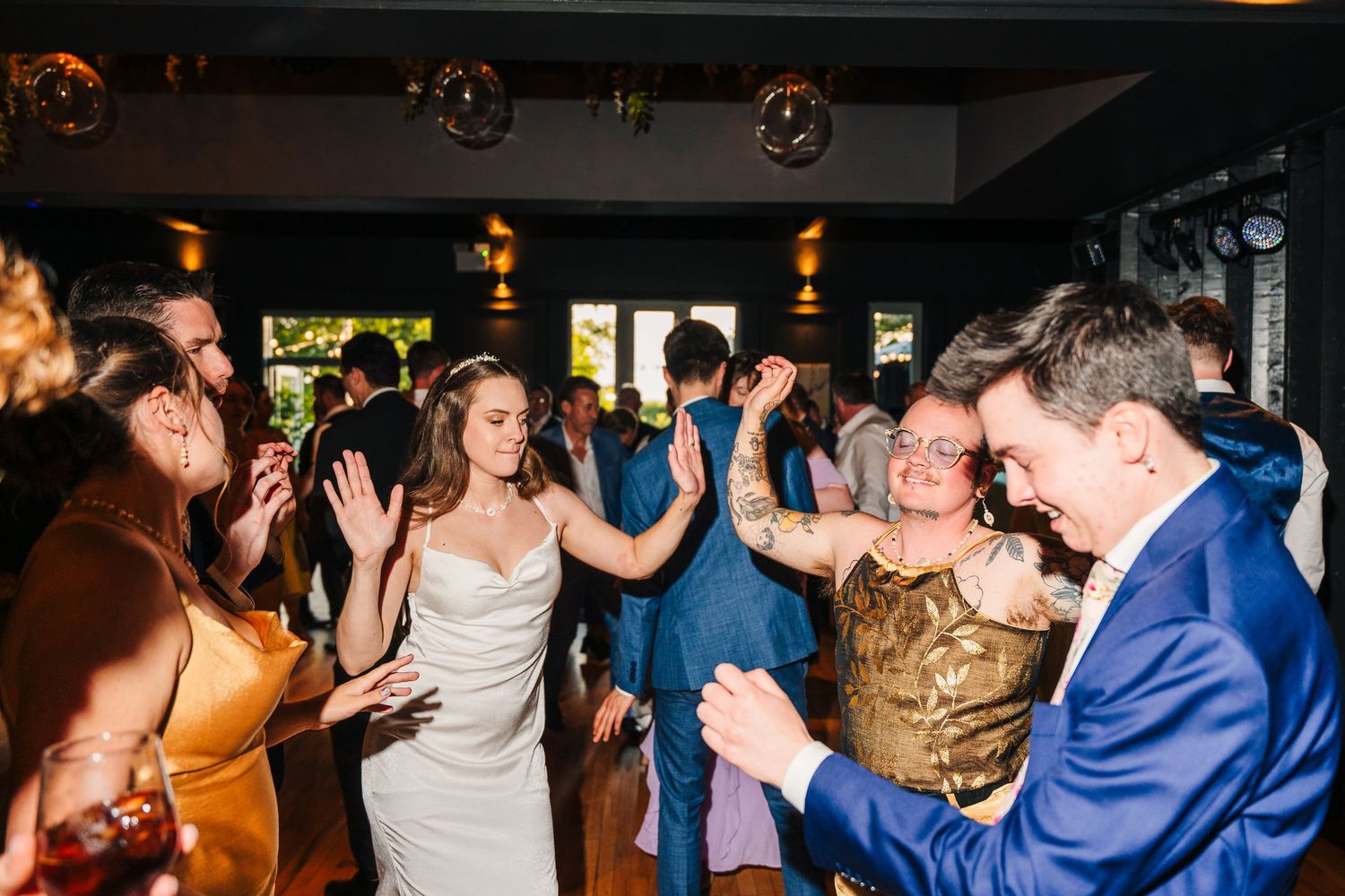 Poulaphouca Wedding photographer wicklow  Wedding reception dance party with guests celebrating on the dance floor under ambient lighting.