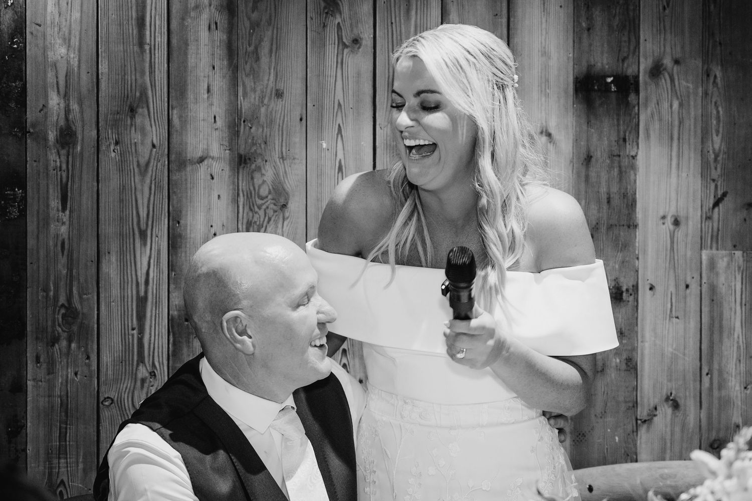 Candid moments shared between a couple against rustic wooden wall backdrop. The Dean Dublin Wedding Photographer