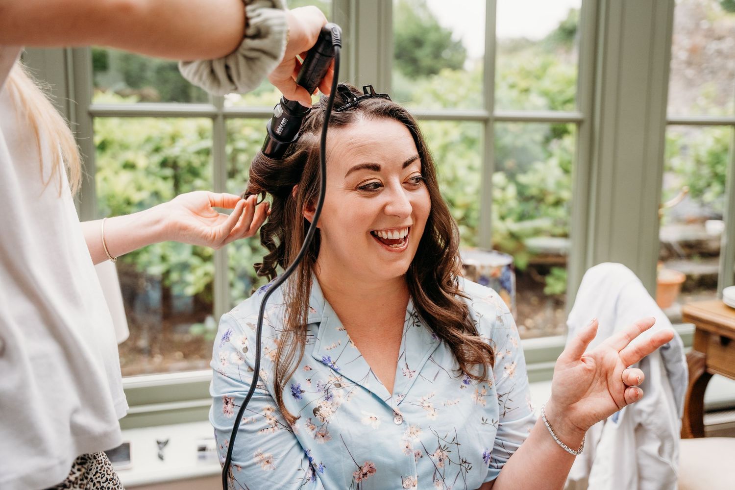 A joyful candid moment captured during a wedding celebration with people laughing together. Wedding photographer Dublin