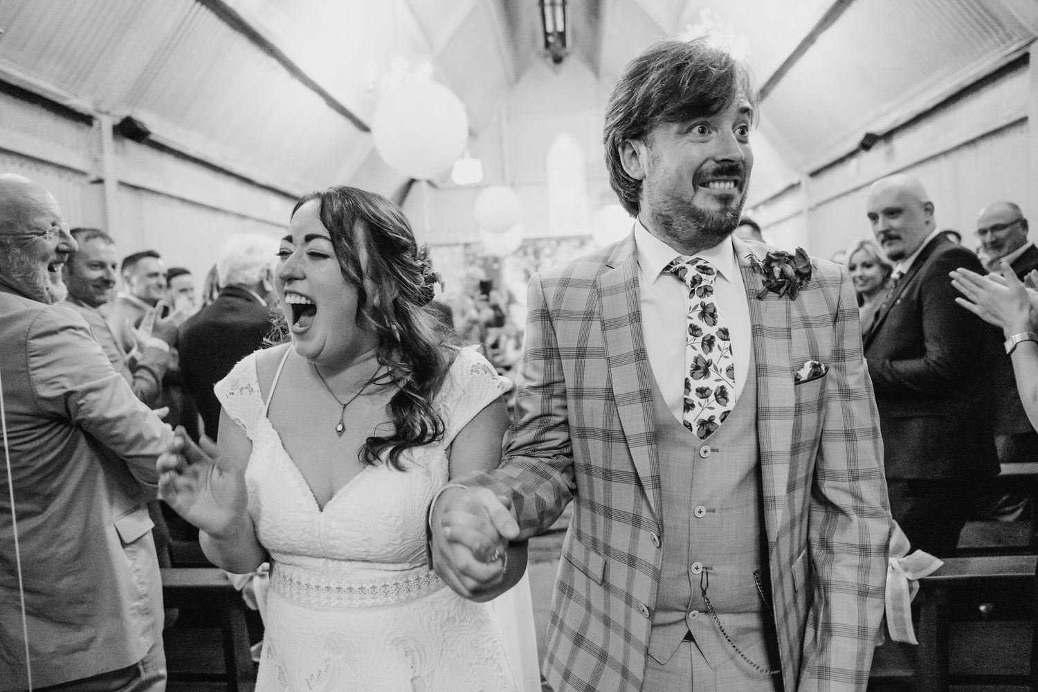 Candid black and white shots of wedding guests celebrating with excitement and laughter. Wedding photographer Dublin