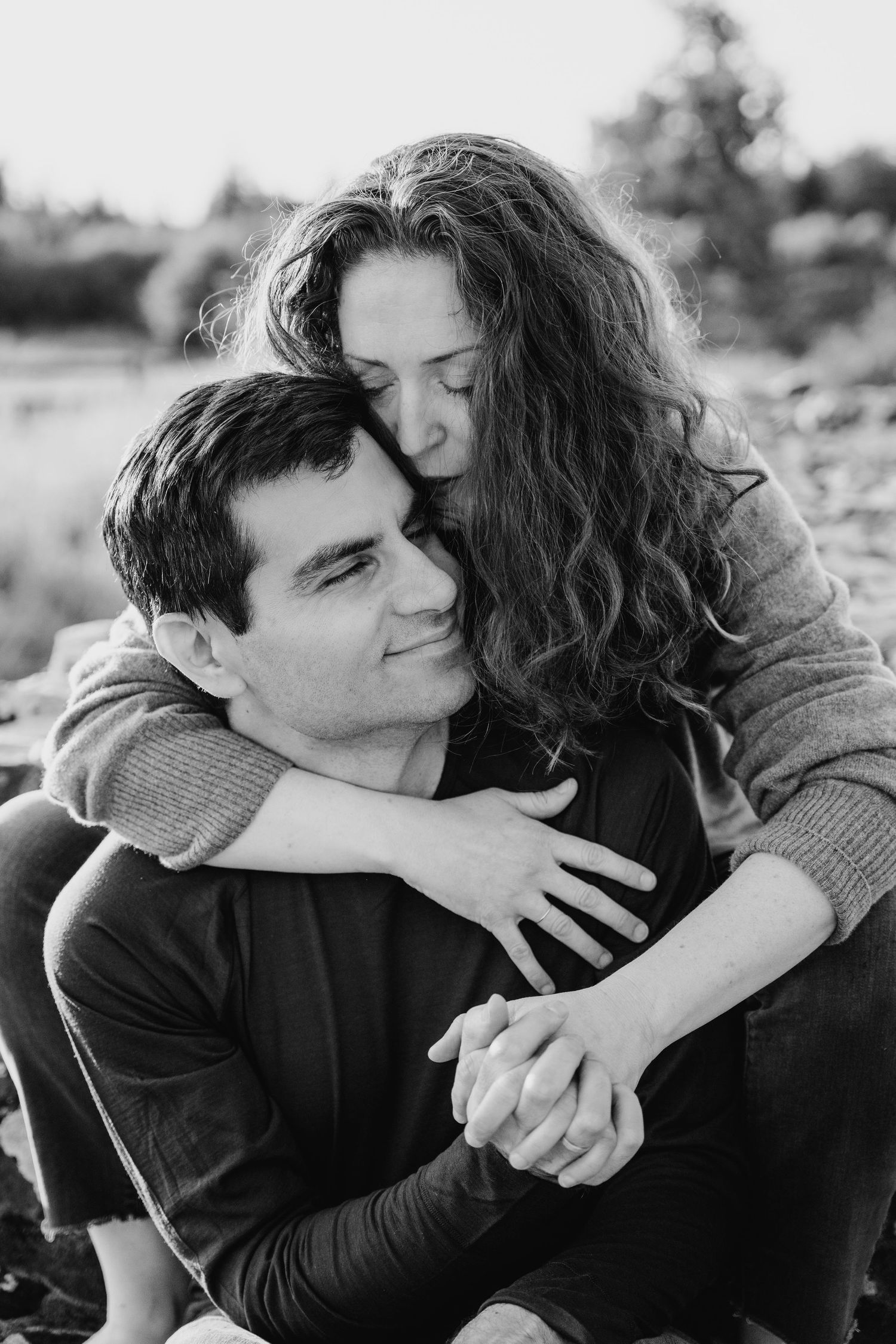 Black and white portrait of a couple embracing outdoors, sharing an intimate moment together. PHOTOGRAPHER Dublin ireland