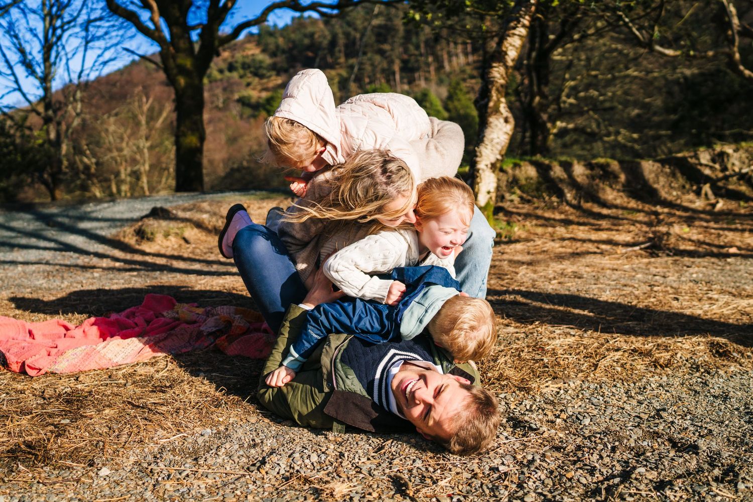 A sequence of candid playful moments between two people enjoying quality time outdoors on a sunny autumn day. family PHOTOGRAPHER Dublin