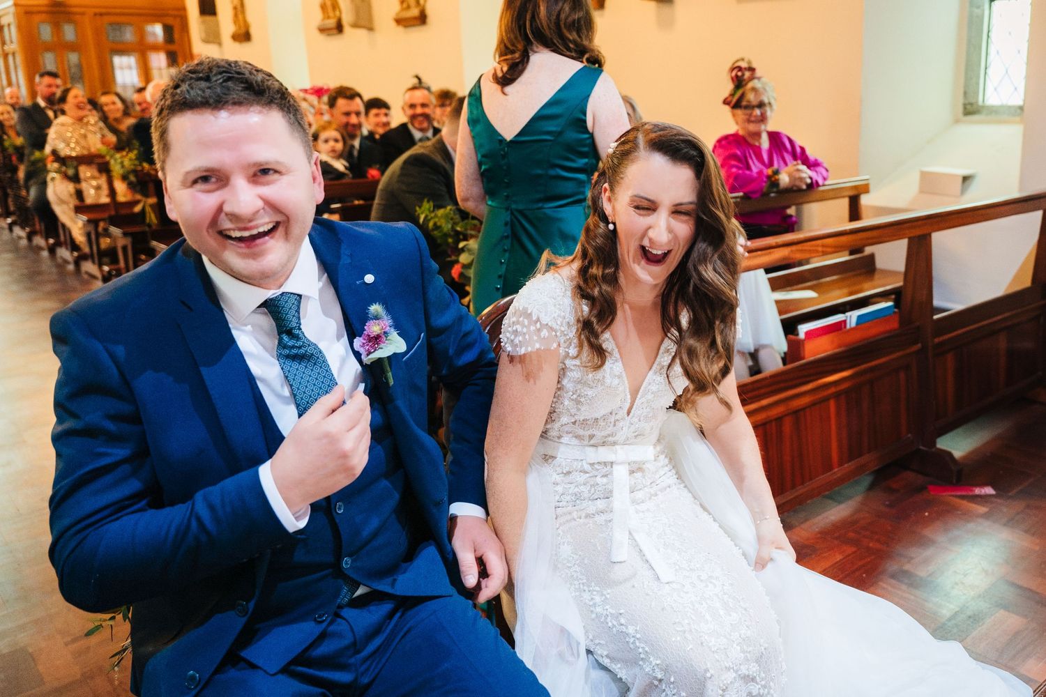 Happy couple exchanging laughter and glances during their wedding ceremony.