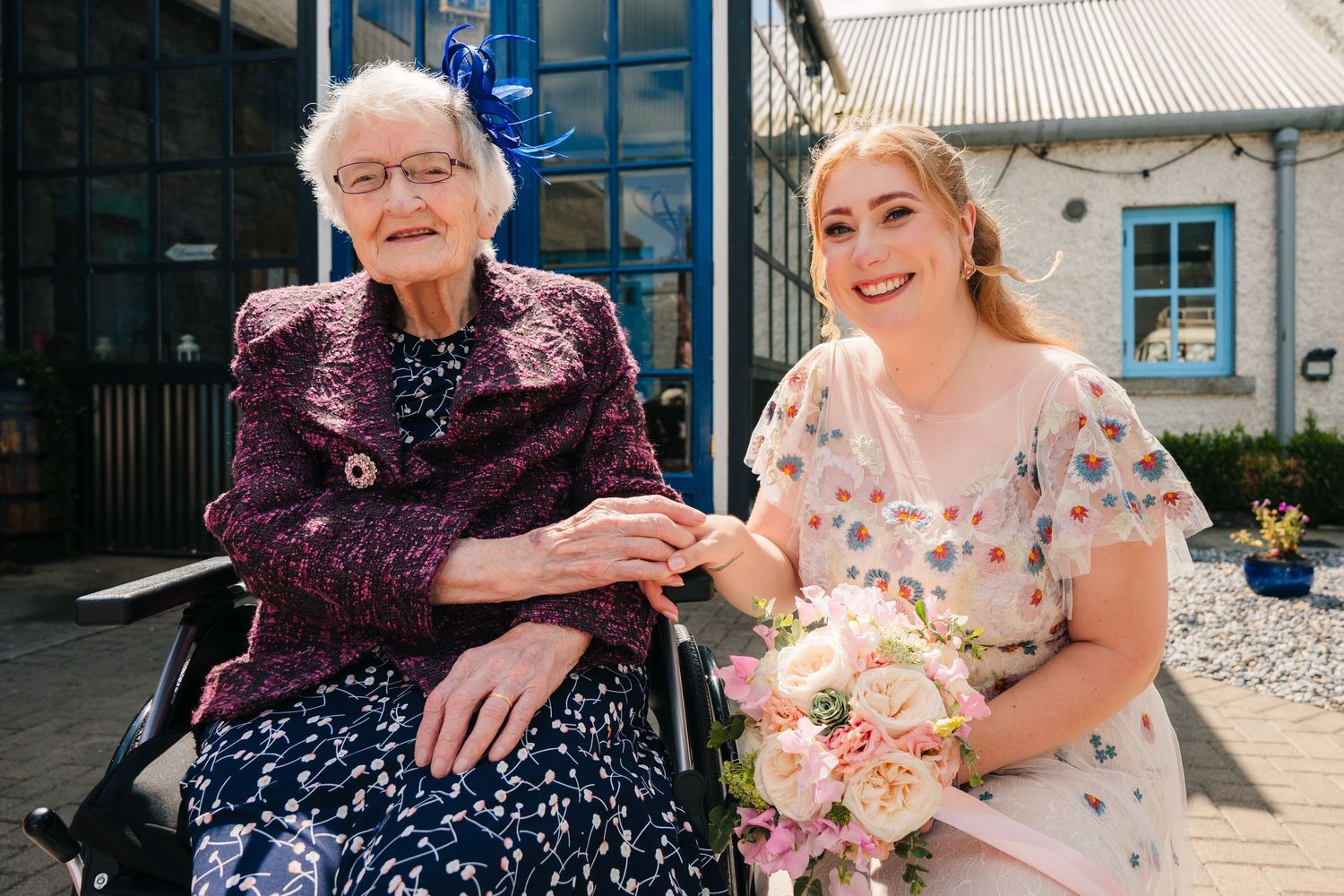 A sunny outdoor moment shared between generations with beautiful flower bouquets. . Village Barn Tyrrellspass wedding photographer Ireland