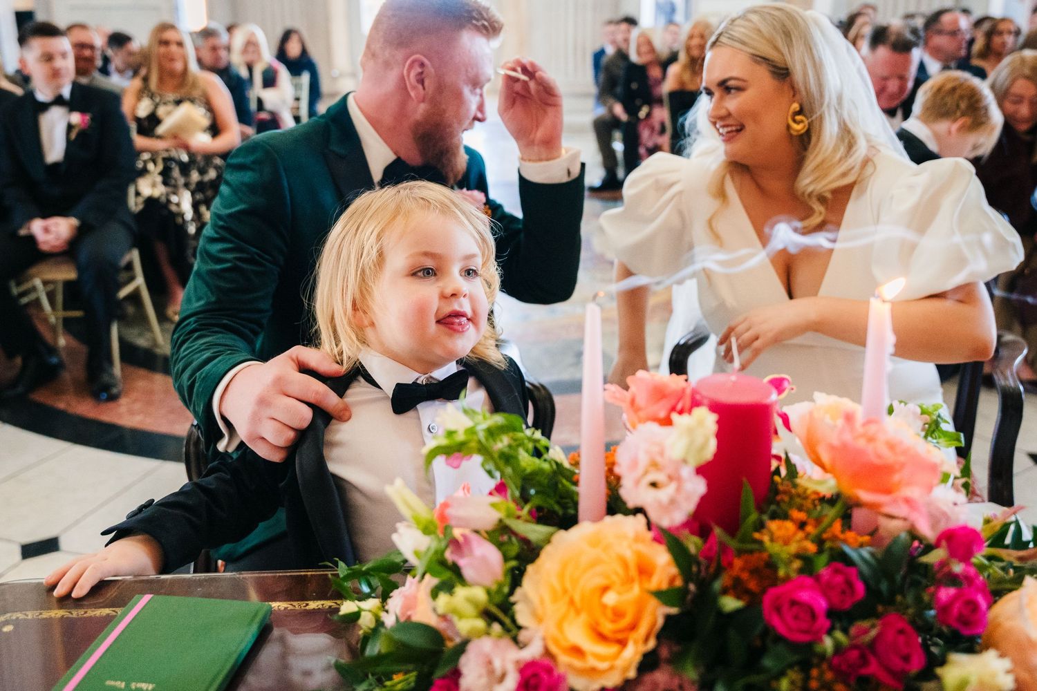 Wedding reception table decorated with vibrant floral arrangements in orange, pink and purple hues. City Hall Dublin Photographer