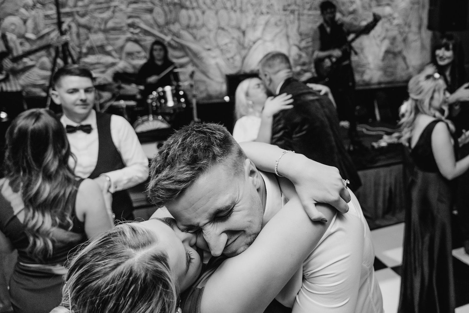 Black and white photo of wedding guests dancing and celebrating at a lively reception party. City Hall Dublin Photographer