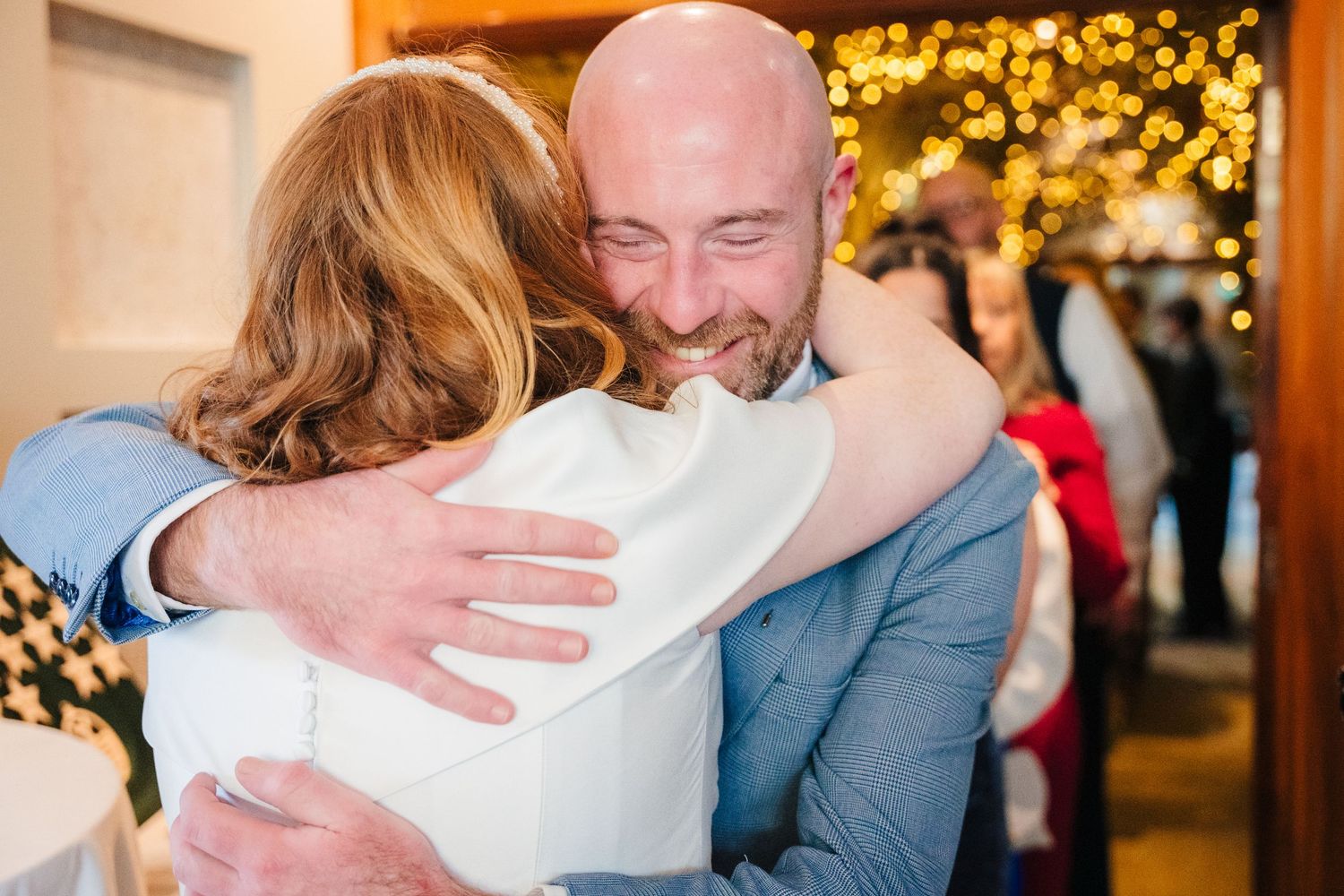 Romantic wedding couple embracing during their first dance under warm lighting.  Wedding PHOTOGRAPHER Trim Castle