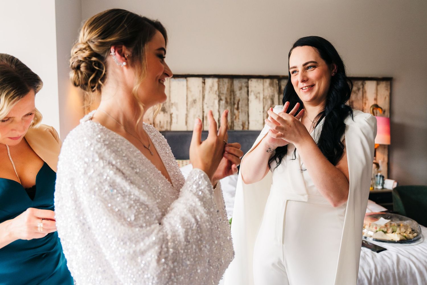 A group getting ready for a wedding celebration in a bridal suite with elegant white lace robes. House Dublin Wedding Photographer