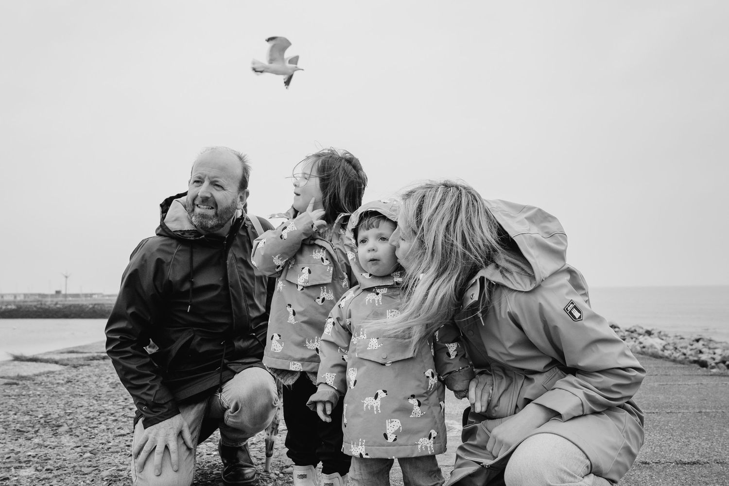 A group enjoys a lighthearted moment together outdoors in black and white photography. PHOTOGRAPHER Dublin