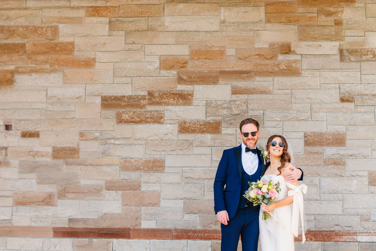 Castle Leslie Wedding Photographer Dublin Elegant wedding portraits captured against a textured stone wall background.