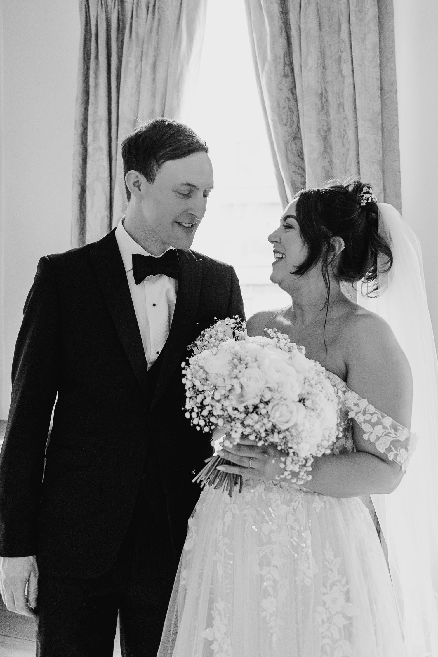 Black and white wedding portraits show tender moments between newlyweds with baby's breath bouquet. Wedding PHOTOGRAPHER Dublin