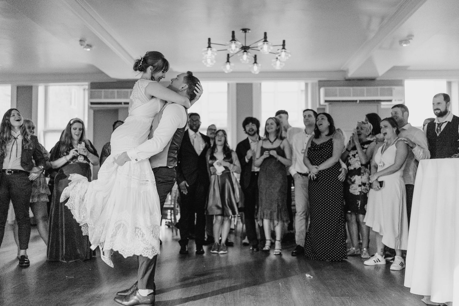 A black and white photo captures a romantic dance dip moment at a wedding reception. PHOTOGRAPHER Dublin Ireland Wedding