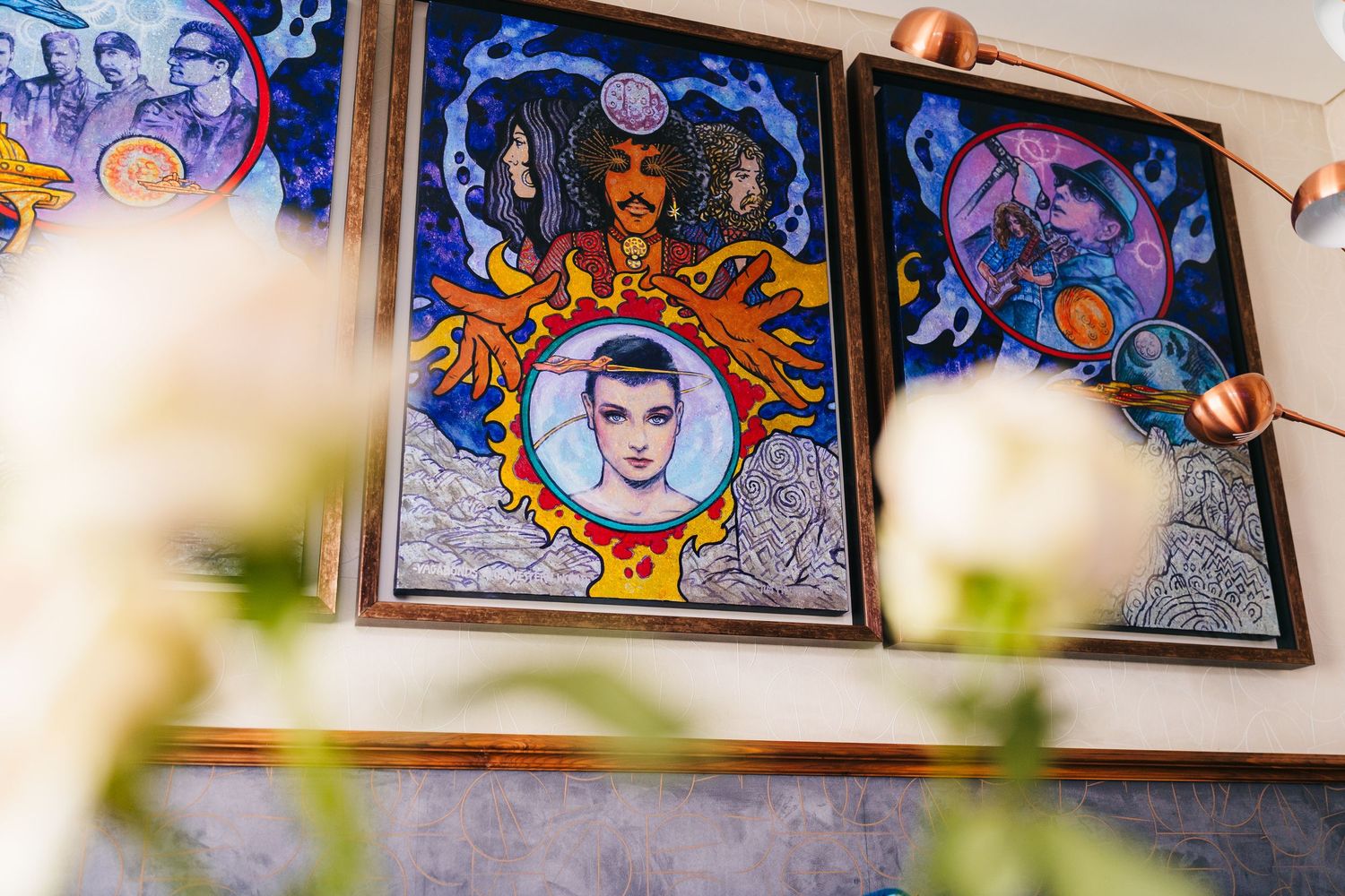 Colorful artistic mural panels with ornate designs and decorative elements hanging on a wall beside  Wedding photographer dublin