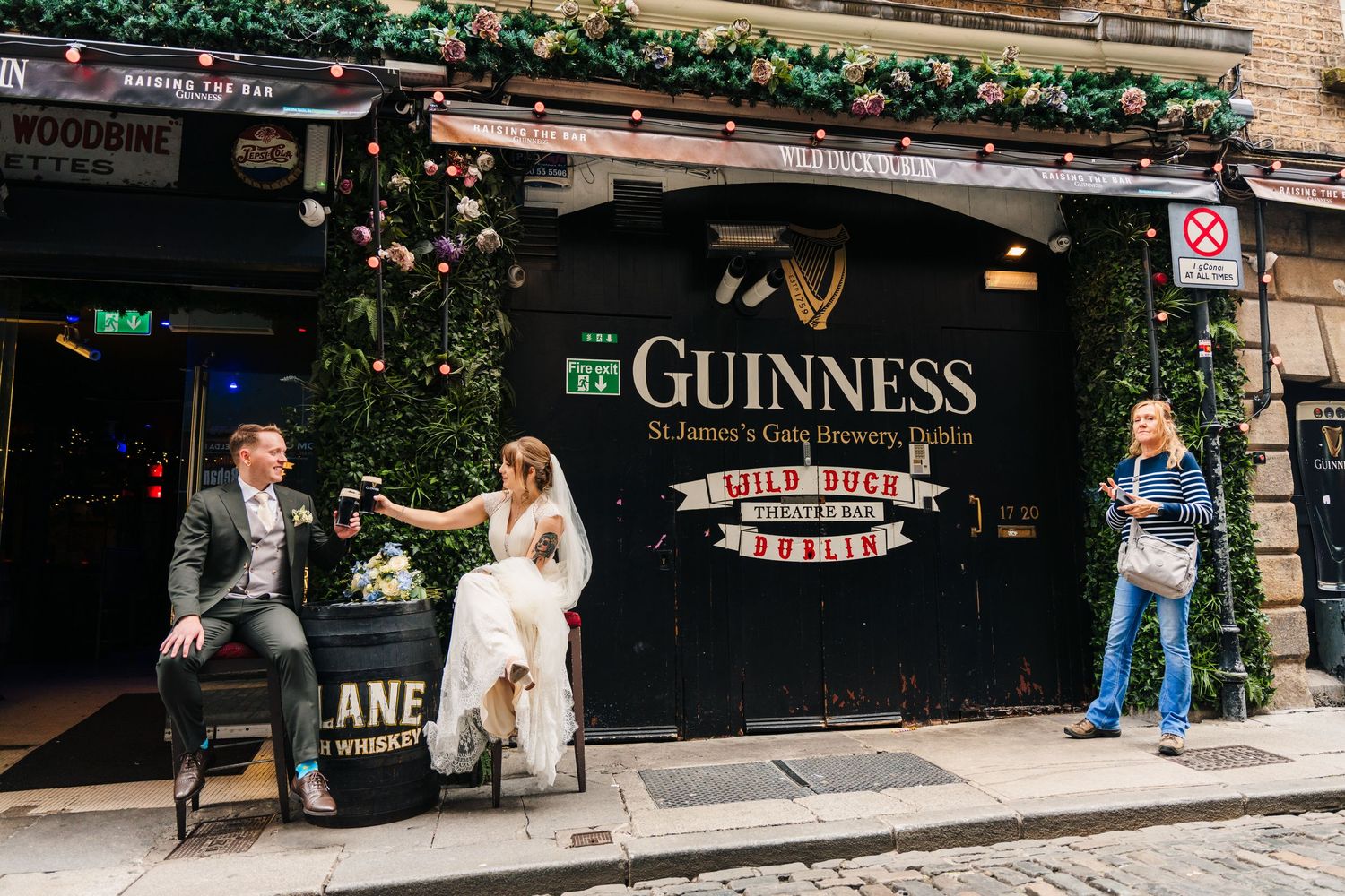Dublin street scene with Guinness pub signage and traditional storefronts. PHOTOGRAPHER Dublin Ireland Wedding