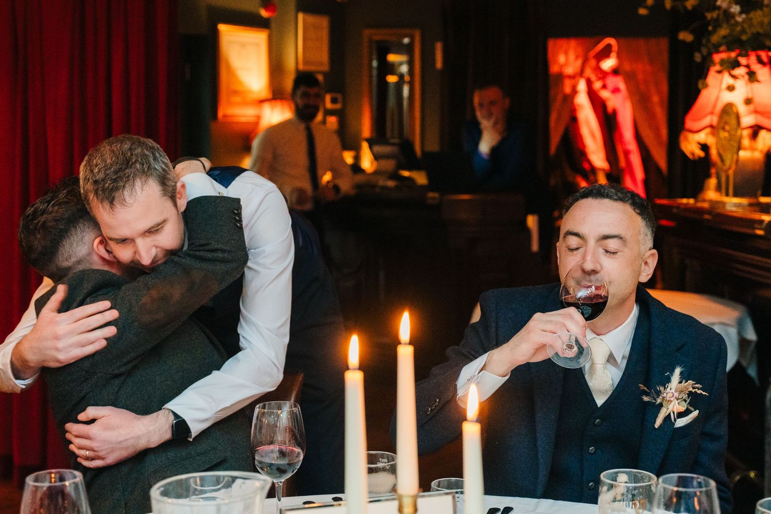 Wedding celebration in a dimly lit restaurant with candlelight and joyful atmosphere. Marco Pierre Dublin Wedding Photographer