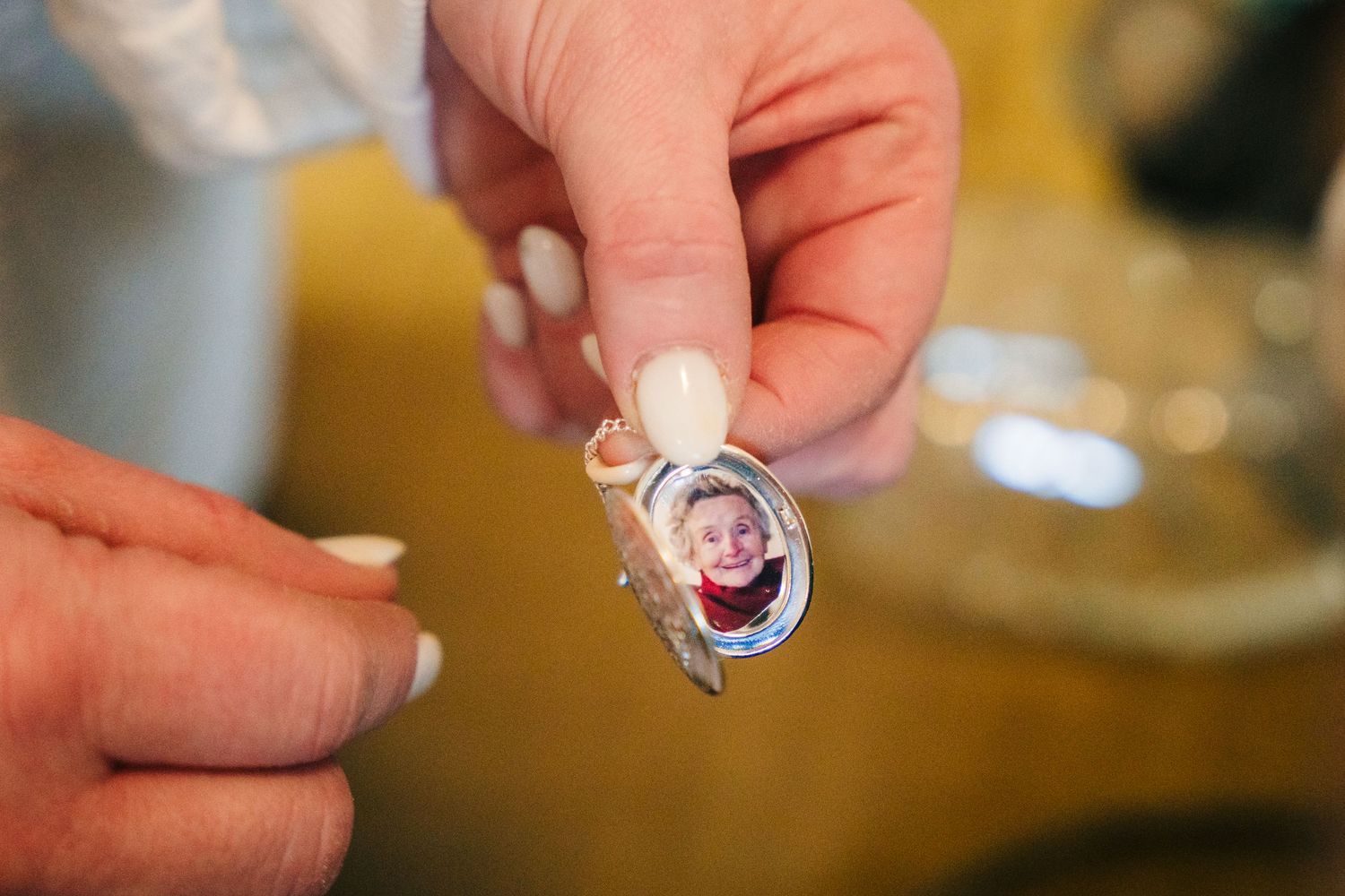 Close-up shots showing hands adjusting jewelry and wedding accessories in preparation for a ceremony.  Wedding PHOTOGRAPHER Trim Castle
