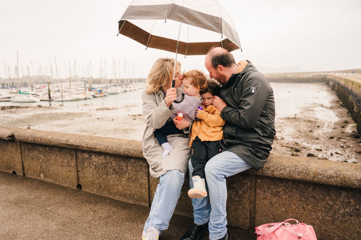 Family enjoying a casual moment together on stone steps by the waterfront. PHOTOGRAPHER Dublin