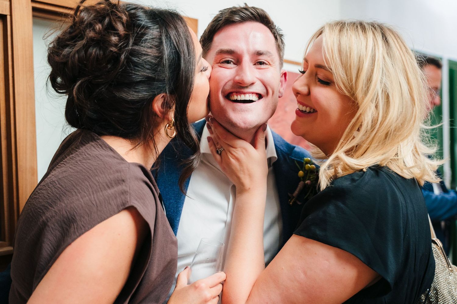Wedding guests share candid moments and laughter during reception celebration. Same sex wedding PHOTOGRAPHER Dublin
