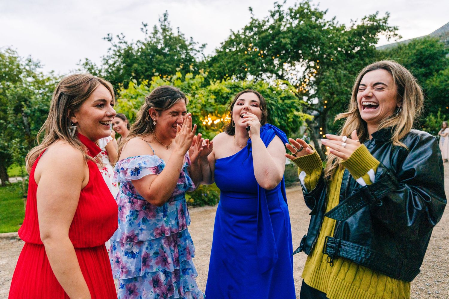 Millhouse slane wedding photographer dublin Wedding guests celebrate and laugh together at an outdoor reception.