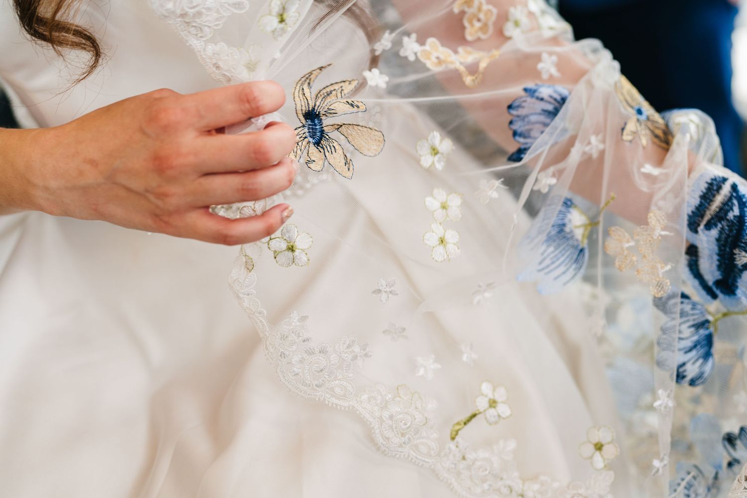 Poulaphouca Wedding photographer wicklow  Close-up of delicate beadwork and embellishments on white wedding dress fabric.