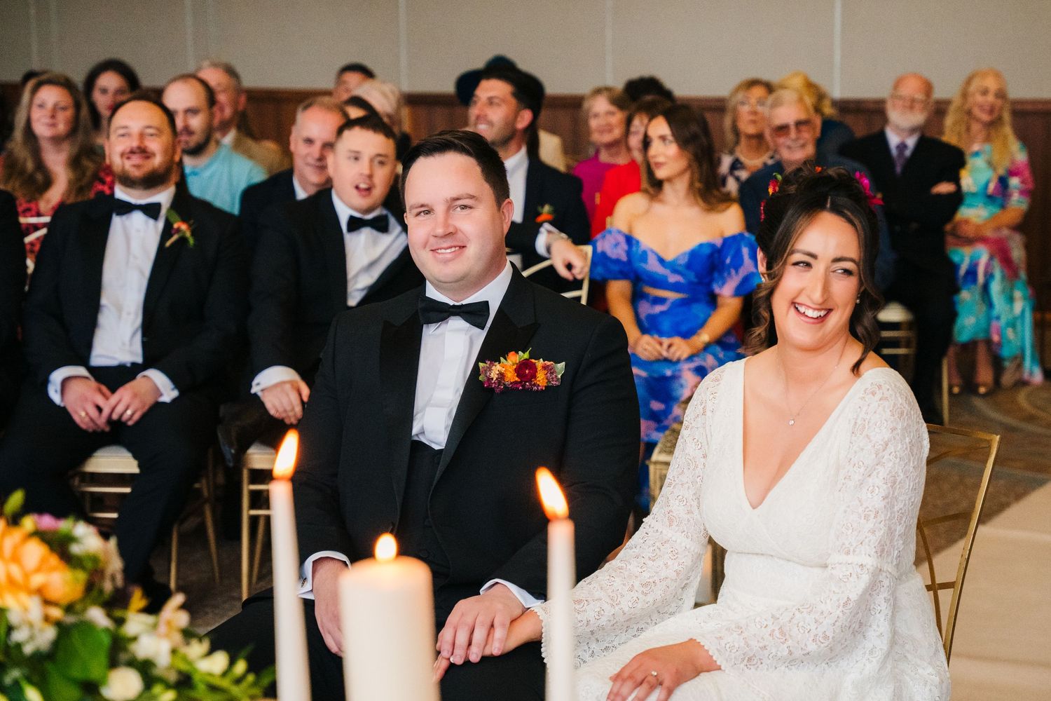 Wedding ceremony guests seated in rows watching intently in formal attire. Wedding Photography Trim Castle Ireland