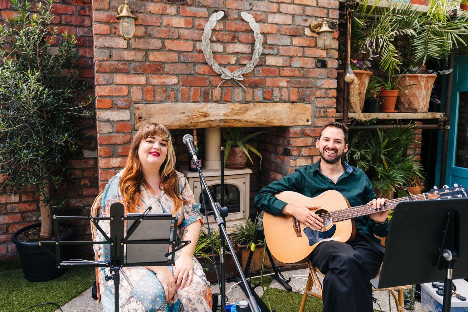 Festive gathering in a garden setting with exposed brick wall backdrop. House Dublin Wedding Photographer