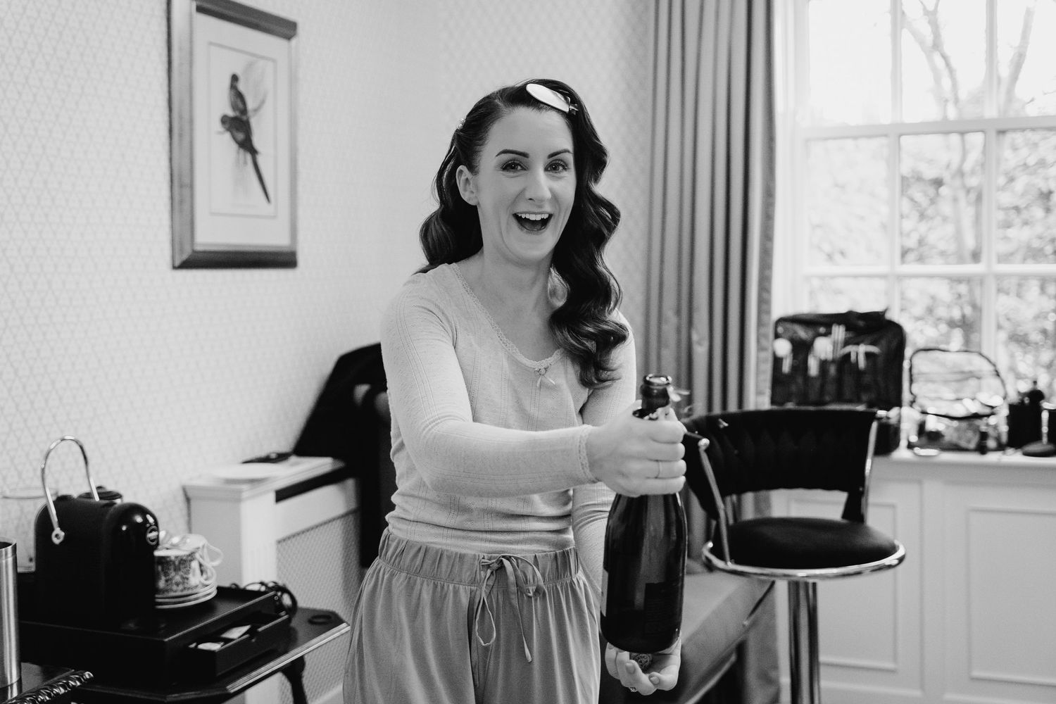 Black and white photo series showing wedding preparations with bride getting ready in elegant vintage-style setting.