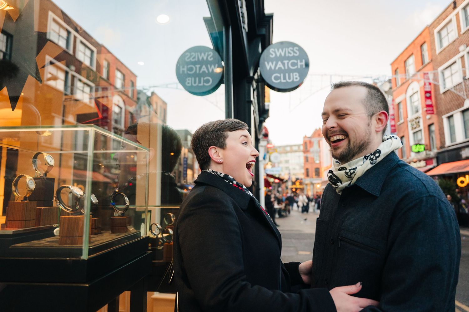 Lively street scene with shops and pedestrians during golden hour. family PHOTOGRAPHER Dublin