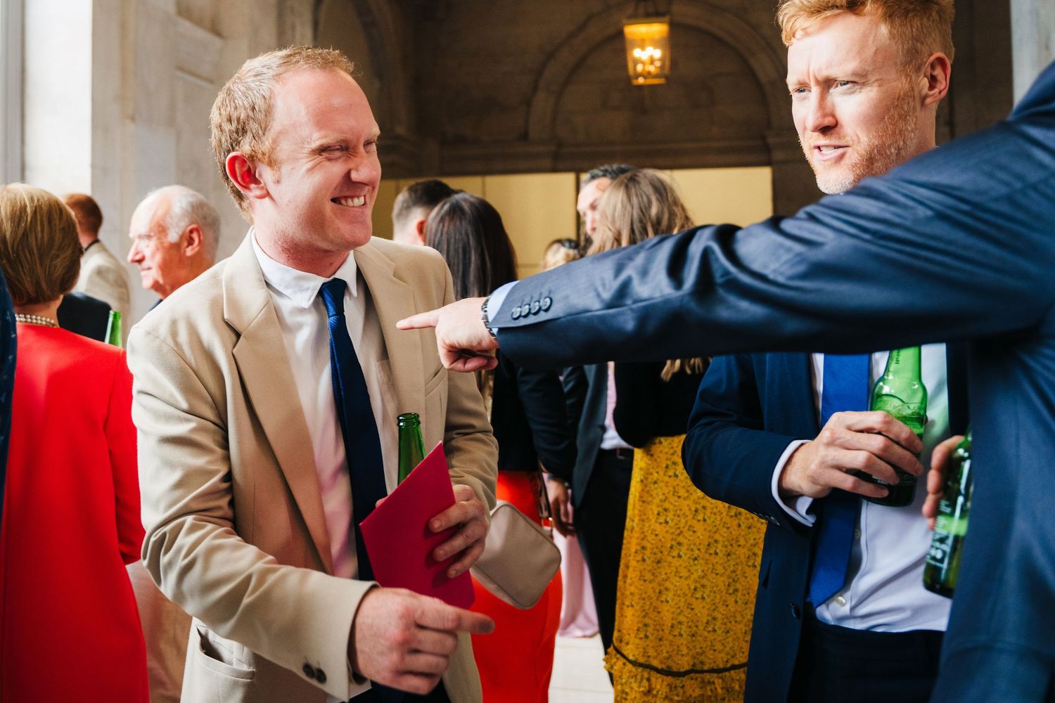 A sequence of celebratory moments showing people toasting and sharing drinks at a formal event.  city hall dublin wedding photos