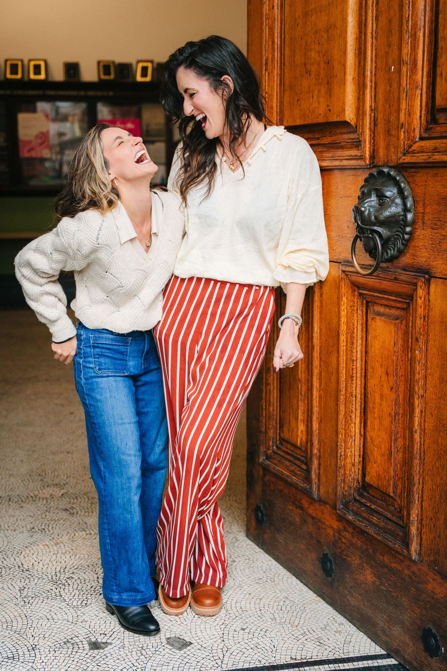 Candid fashion poses by wooden doors showing casual style with striped pants and denim. professional headshots dublin photographer