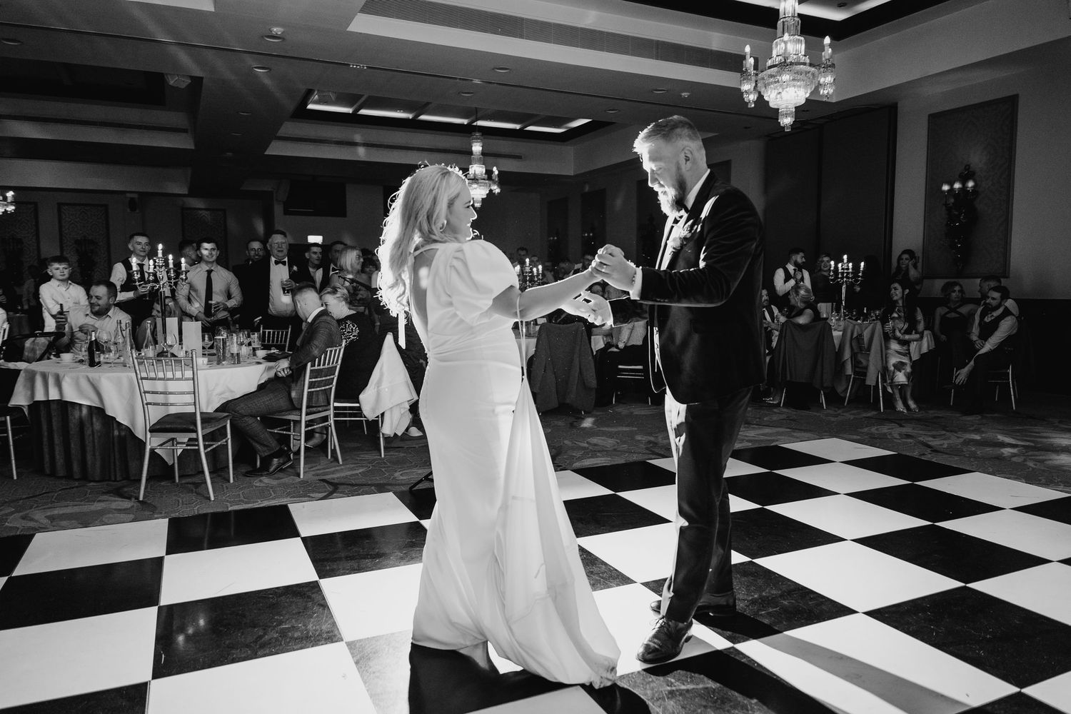 Wedding reception sequence showing dancing on a black and white checkered dance floor. Wedding photographer dublin