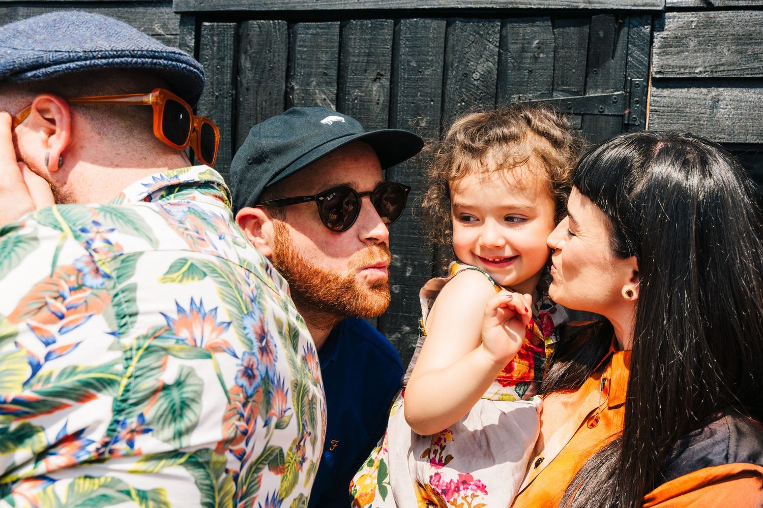 Group of people outdoors including a person in a floral shirt and another wearing a black cap on a sunny day. family PHOTOGRAPHER Dublin