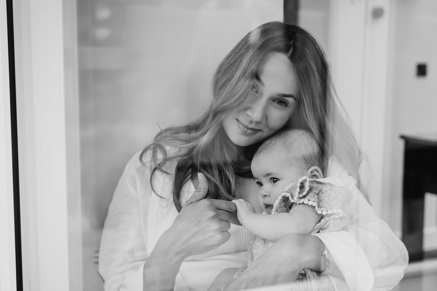 A black and white photo montage shows tender moments between a mother and baby in various intimate poses. family PHOTOGRAPHER Dublin