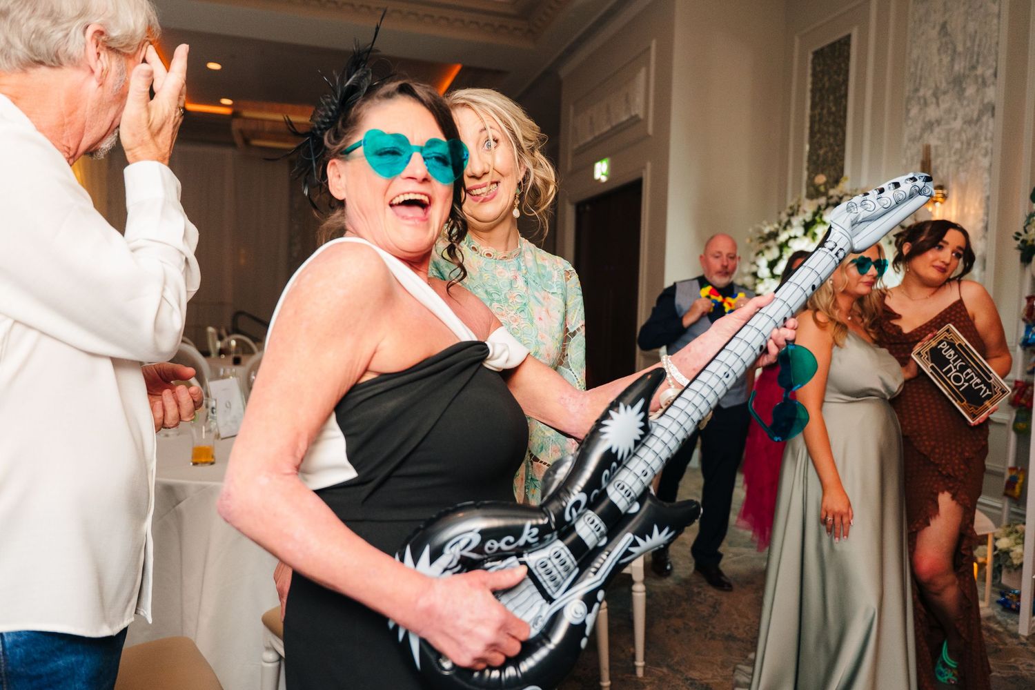 Wedding guests dancing and celebrating on the dance floor during reception. Wedding PHOTOGRAPHER Dublin
