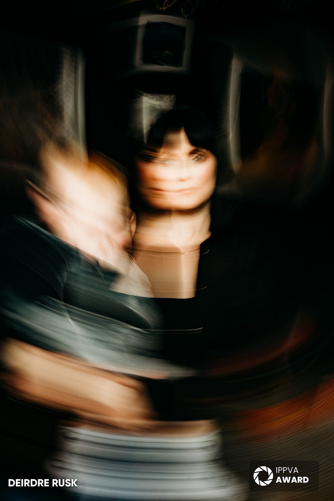 An artistic motion blur photograph capturing an intimate moment in low light. PHOTOGRAPHER Dublin