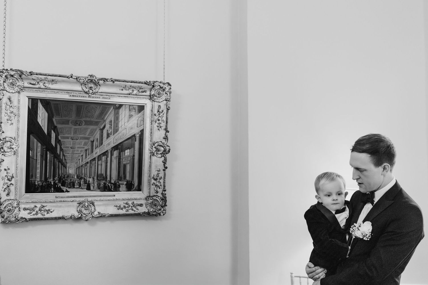 A series of black and white photographs displayed together showing people gathered indoors in formal attire.  Wedding PHOTOGRAPHER Dublin