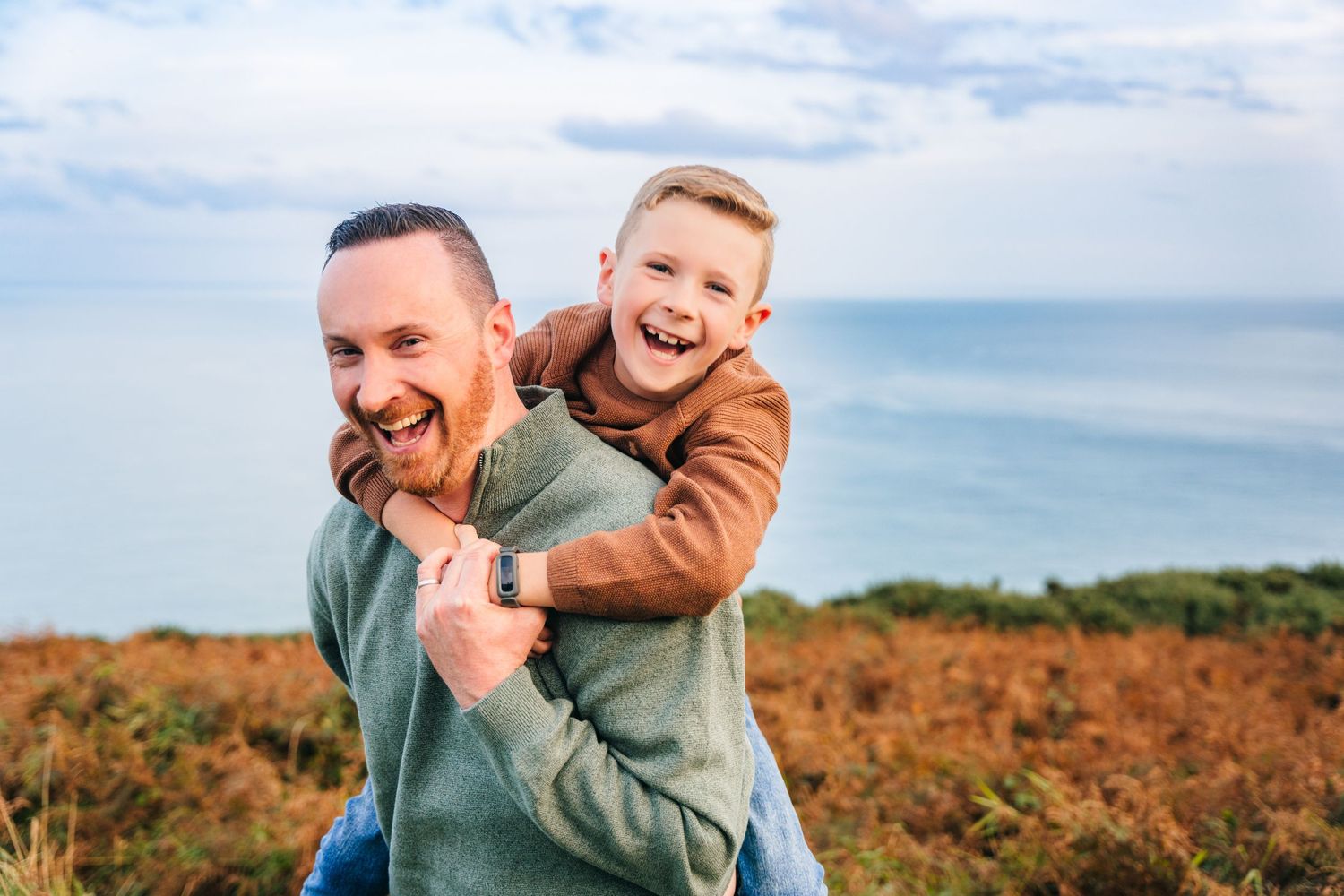 A series of joyful moments captured between parent and child playing together outdoors against a landscape. Family photographer dublin