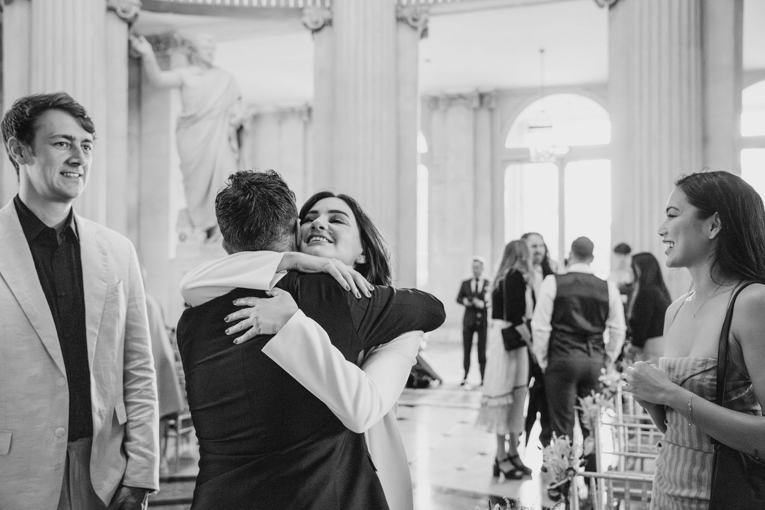 Elegant wedding celebration in a grand room with classical columns and architecture.  city hall dublin wedding photos