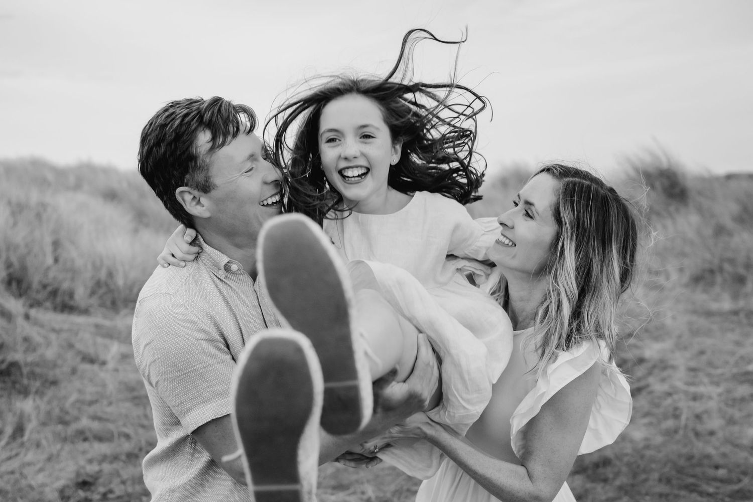 Black and white photo collage showing romantic couples embracing and laughing together outdoors in natural Dublin Family photographer