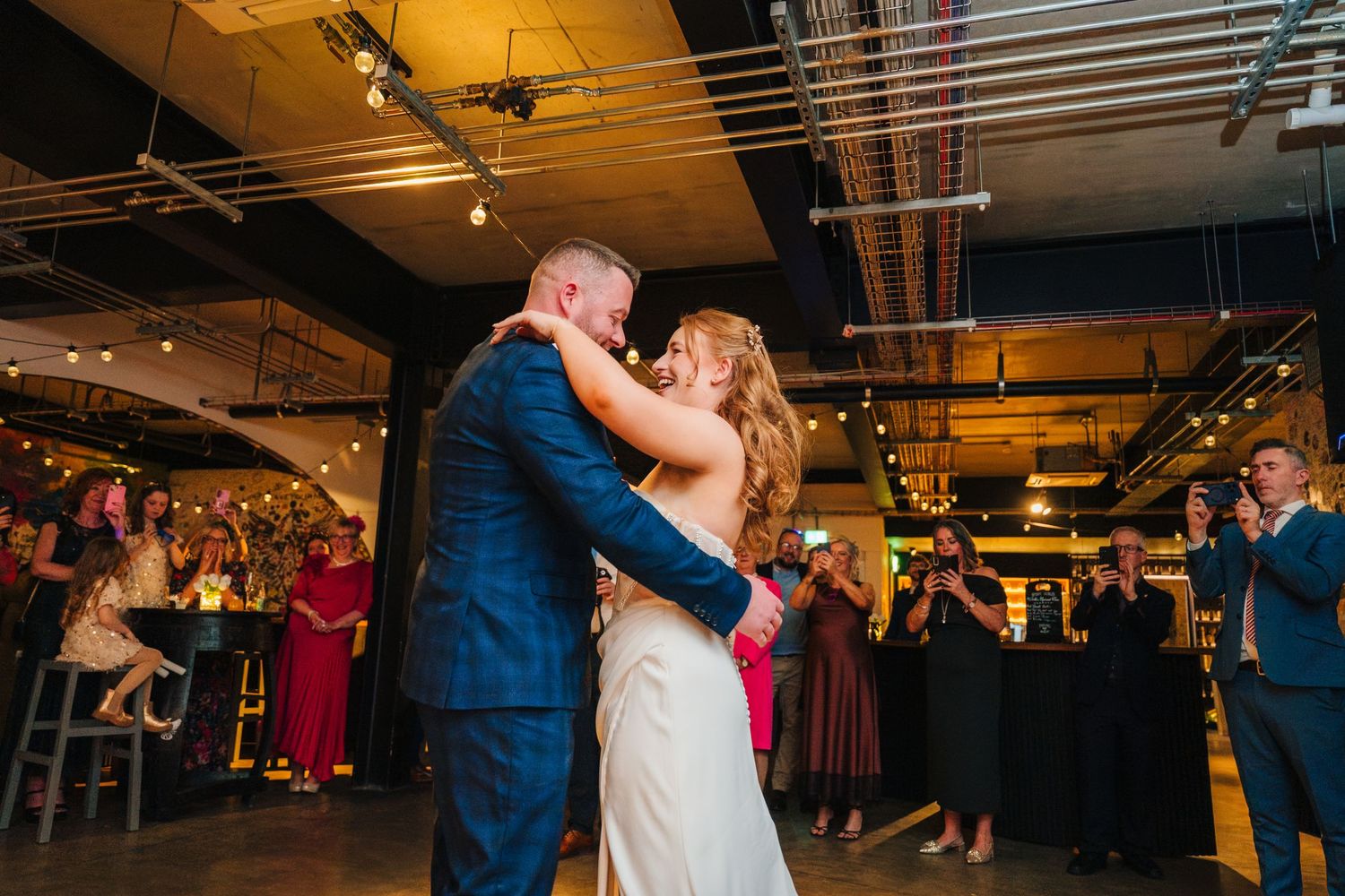 Couple sharing an intimate dance moment at their wedding reception under warm lighting. Dublin wedding photogrAPher