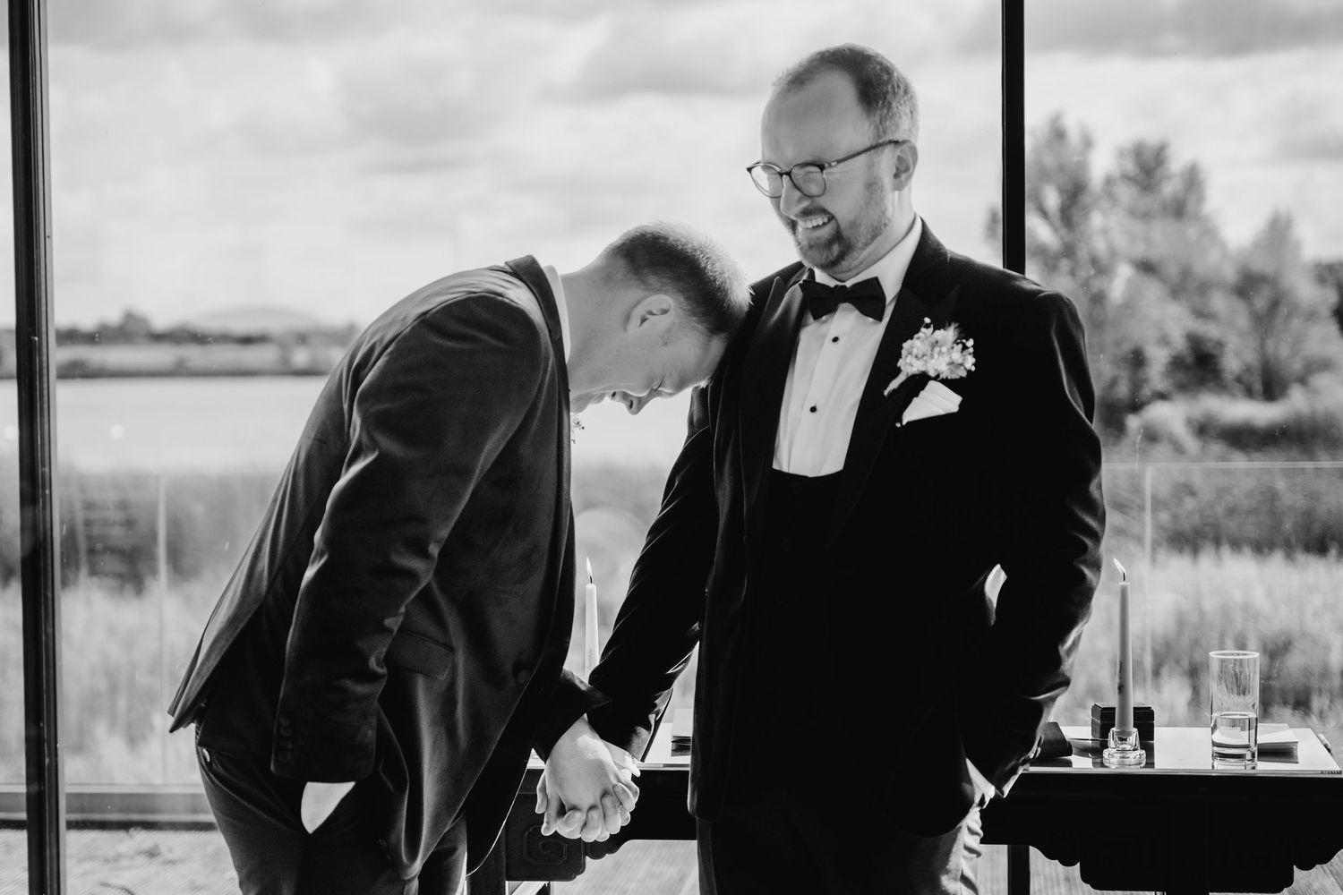 Black and white wedding photos showing groomsmen in tuxedos walking and posing outdoors. Wedding photographer dublin