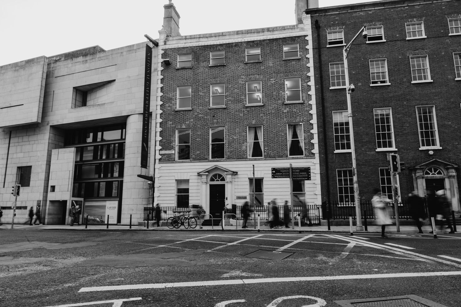 Black and white photo of historic Georgian buildings on a city street with brick facades and bay windows. Wedding PHOTOGRAPHER Dublin