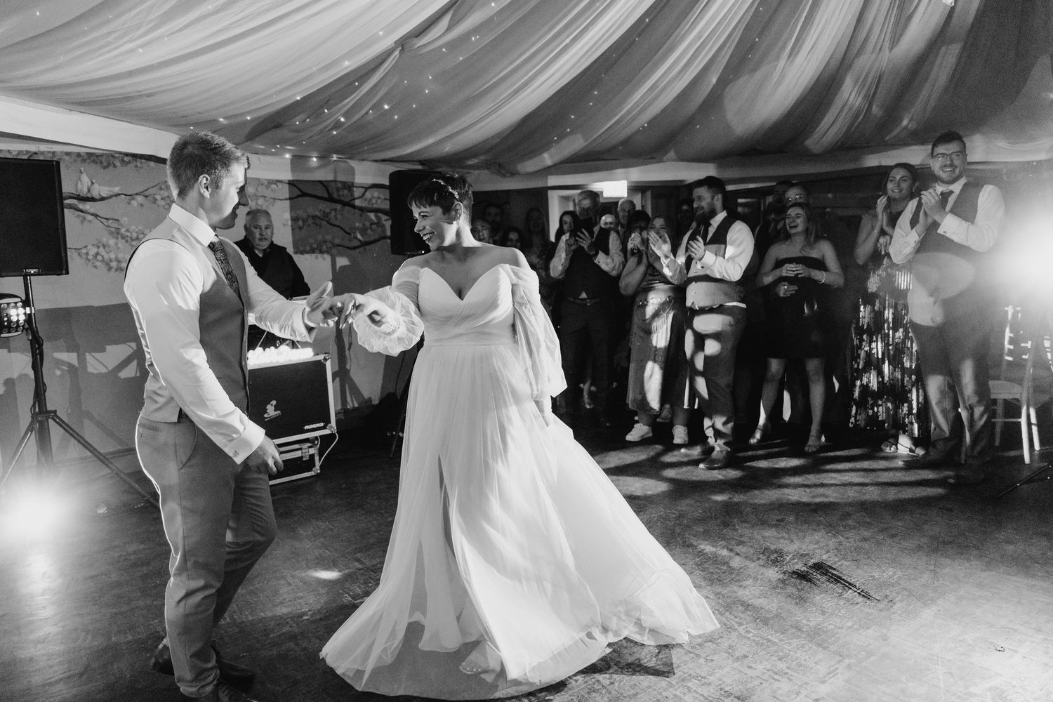 Millhouse slane wedding photographer dublin Black and white shots of wedding dance floor moments under draped fabric ceiling.