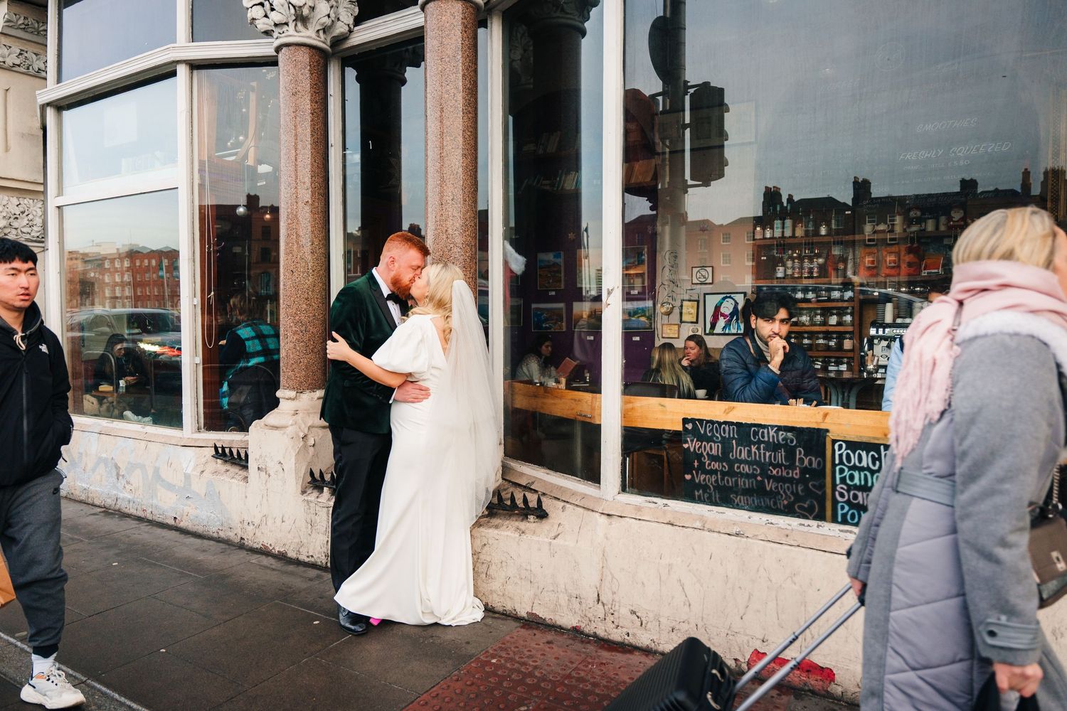 Candid wedding moments captured on a city street with storefronts in the background. City Hall Dublin Photographer